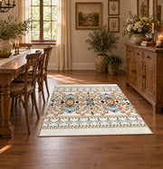 Cream and blue folk floral area rug with orange botanical details, front room mockup