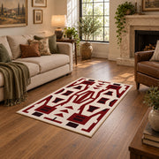 Burgundy and cream geometric area rug with a bold interlocking pattern, cozy home setting