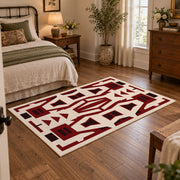 Burgundy and cream geometric area rug with a bold interlocking pattern, soft surface detail