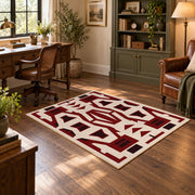 Burgundy and cream geometric area rug with a bold interlocking pattern, wood floor styling