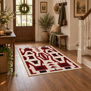 Burgundy and cream geometric area rug with a bold interlocking pattern, close decorative detail
