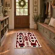 Burgundy and cream geometric area rug with a bold interlocking pattern, wide interior view