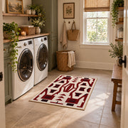 Burgundy and cream geometric area rug with a bold interlocking pattern, design detail view