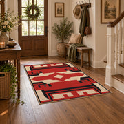 Red and black tribal cross area rug with cream geometric details, wood floor styling