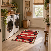 Red and black tribal cross area rug with cream geometric details, wide interior view