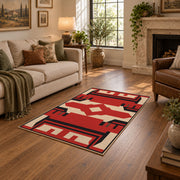 Red and black tribal cross area rug with cream geometric details, design detail view