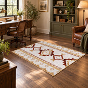 Cream and rust tribal area rug with brown and gold diamond motifs, soft surface detail