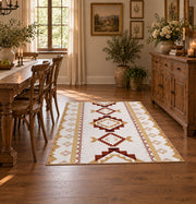 Cream and rust tribal area rug with brown and gold diamond motifs, close decorative detail