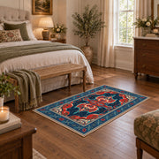 Teal and red Persian area rug with ornate floral details and a patterned border, cozy home setting