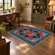 Teal and red Persian area rug with ornate floral details and a patterned border, wood floor styling