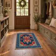 Teal and red Persian area rug with ornate floral details and a patterned border, wide interior view