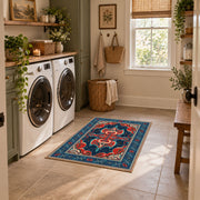 Teal and red Persian area rug with ornate floral details and a patterned border, design detail view
