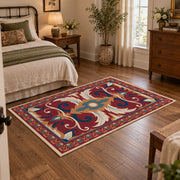 Red and blue ornate floral area rug with cream and teal scroll motifs, soft surface detail