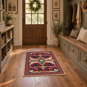Red and blue ornate floral area rug with cream and teal scroll motifs, front room mockup