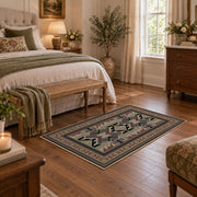 Gray and brown Southwestern area rug with black tribal geometric motifs, cozy home setting