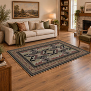 Gray and brown Southwestern area rug with black tribal geometric motifs, angled room view