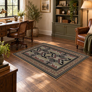 Gray and brown Southwestern area rug with black tribal geometric motifs, wood floor styling