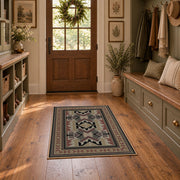 Gray and brown Southwestern area rug with black tribal geometric motifs, front room mockup