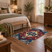Blue and red tribal medallion area rug with cream and teal accents, cozy home setting