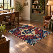 Blue and red tribal medallion area rug with cream and teal accents, soft surface detail