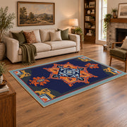 Navy and orange tribal area rug with red and cream geometric details, angled room view