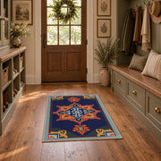 Navy and orange tribal area rug with red and cream geometric details, front room mockup