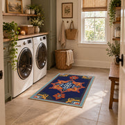 Navy and orange tribal area rug with red and cream geometric details, wide interior view
