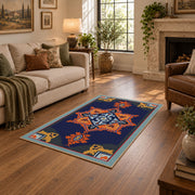 Navy and orange tribal area rug with red and cream geometric details, design detail view