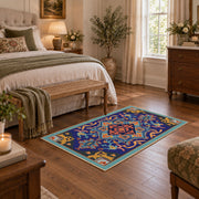 Blue and orange star medallion area rug with red geometric accents, cozy home setting