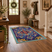 Blue and orange star medallion area rug with red geometric accents, wood floor styling