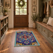 Blue and orange star medallion area rug with red geometric accents, front room mockup