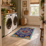 Blue and orange star medallion area rug with red geometric accents, wide interior view