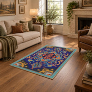 Blue and orange star medallion area rug with red geometric accents, design detail view