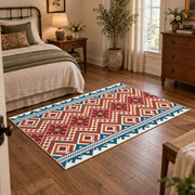 Red and cream diamond area rug with blue and black Southwestern details, full pattern view