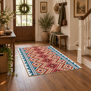 Red and cream diamond area rug with blue and black Southwestern details, wood floor styling