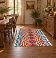 Red and cream diamond area rug with blue and black Southwestern details, close decorative detail