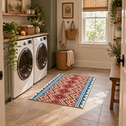 Red and cream diamond area rug with blue and black Southwestern details, wide interior view