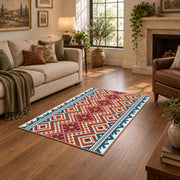 Red and cream diamond area rug with blue and black Southwestern details, design detail view
