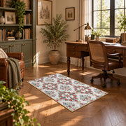 Cream and red floral vine area rug with teal and blue botanical details, complete product view