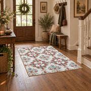 Cream and red floral vine area rug with teal and blue botanical details, wood floor styling