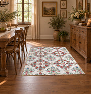 Cream and red floral vine area rug with teal and blue botanical details, close decorative detail