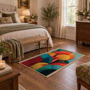 Colorful vintage geometric botanical area rug styled in a restful bedroom