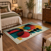 Colorful vintage geometric figurative art area rug displayed beside a cozy bed