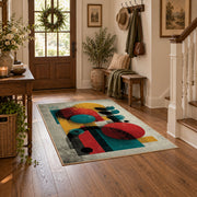 Colorful vintage geometric figurative art area rug styled in a welcoming entryway
