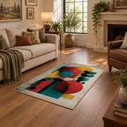 Colorful vintage geometric figurative art area rug shown beside a comfortable sofa