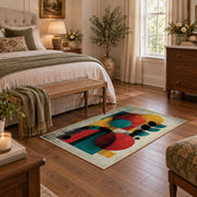 Colorful vintage geometric figurative art area rug styled in a restful bedroom