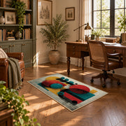 Colorful vintage geometric figurative art area rug displayed in a sunlit home office