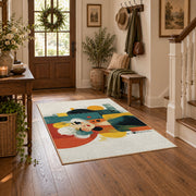 Colorful vintage geometric family portrait area rug styled in a welcoming entryway