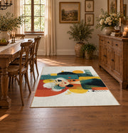 Colorful vintage geometric family portrait area rug shown in a bright dining space