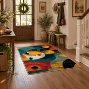 Colorful vintage geometric child portrait area rug styled in a welcoming entryway